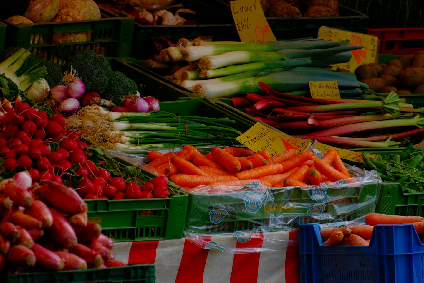 Fresh vegetables displayed at an outdoor market stall.